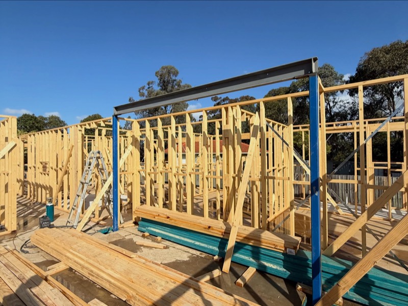 Structural steel beam installed through the timber wall frames